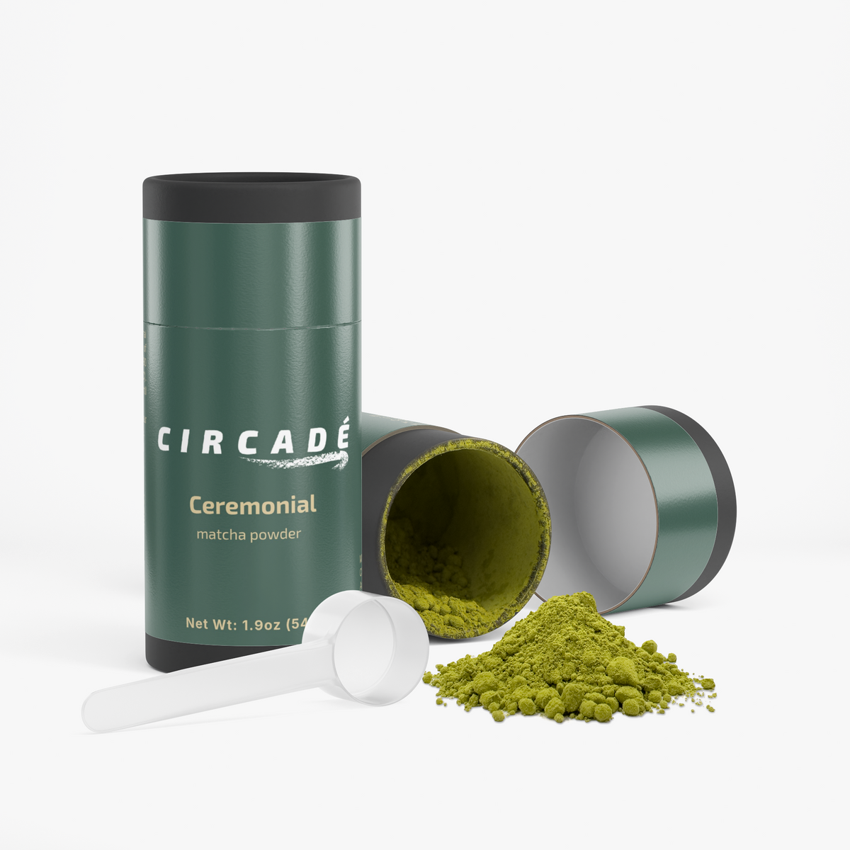 Circade matcha tin beside its open lid, a scoop and a pile of green matcha powder