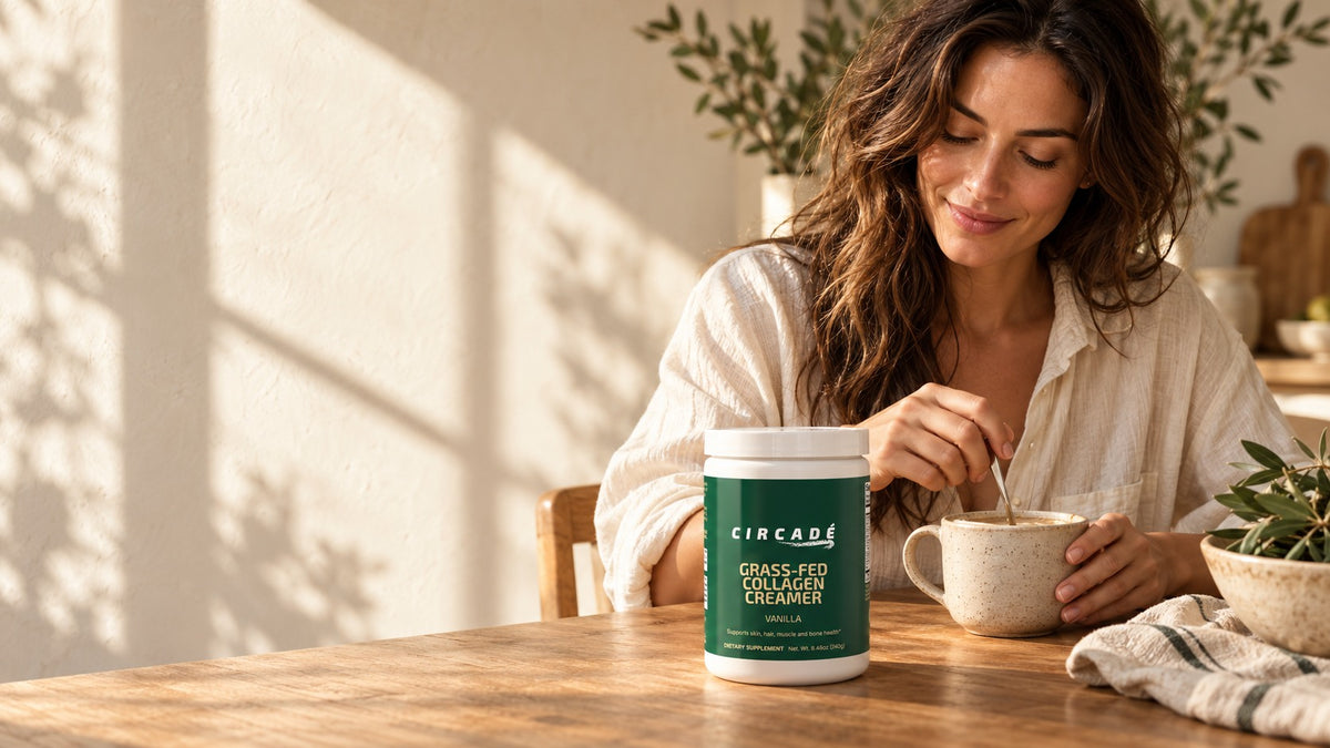 Woman stirring coffee beside Circade Grass-Fed Collagen Creamer at a sunlit breakfast table