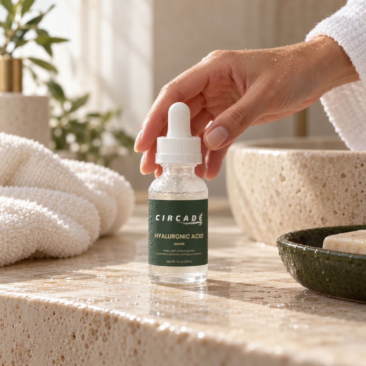 Hand reaching for Circade Hyaluronic Acid Serum on a bathroom counter
