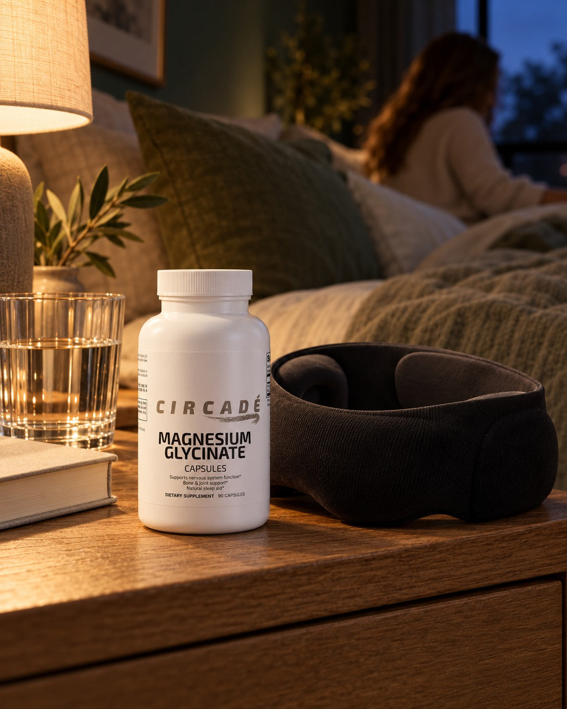 Circade Magnesium Glycinate and a weighted sleep mask on a softly lit bedside table